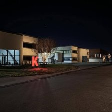 Commercial campus with evenly spaced tree uplighting along the street
