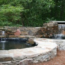 Garden water feature with stacked stone waterfalls