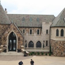 Stone and brick exterior of luxury home with detailed hardscape finishes