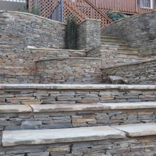 Terraced stone retaining walls with natural stone staircase