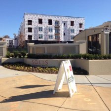 Modern apartment community monument sign with surrounding landscaping