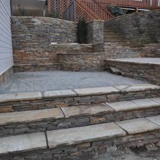 Stone steps and terraced retaining walls built with stacked stone