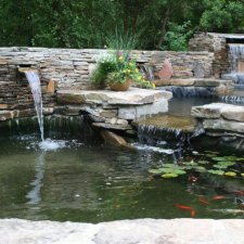 Multi-level koi pond with waterfalls and stone surround