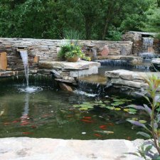 Multi-level koi pond with waterfalls and stone surround