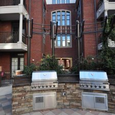 Outdoor dual stainless steel grill station with stone base