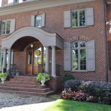 Front entry landscaping with brick steps, planters, and foundation shrubs