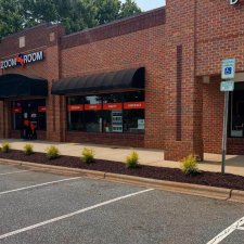 Storefront landscaping with mulched shrub row along sidewalk