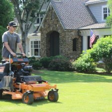 Professional lawn mowing service on a residential property
