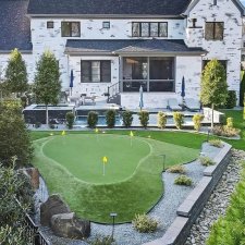 Luxury home with full backyard putting green and landscape lighting